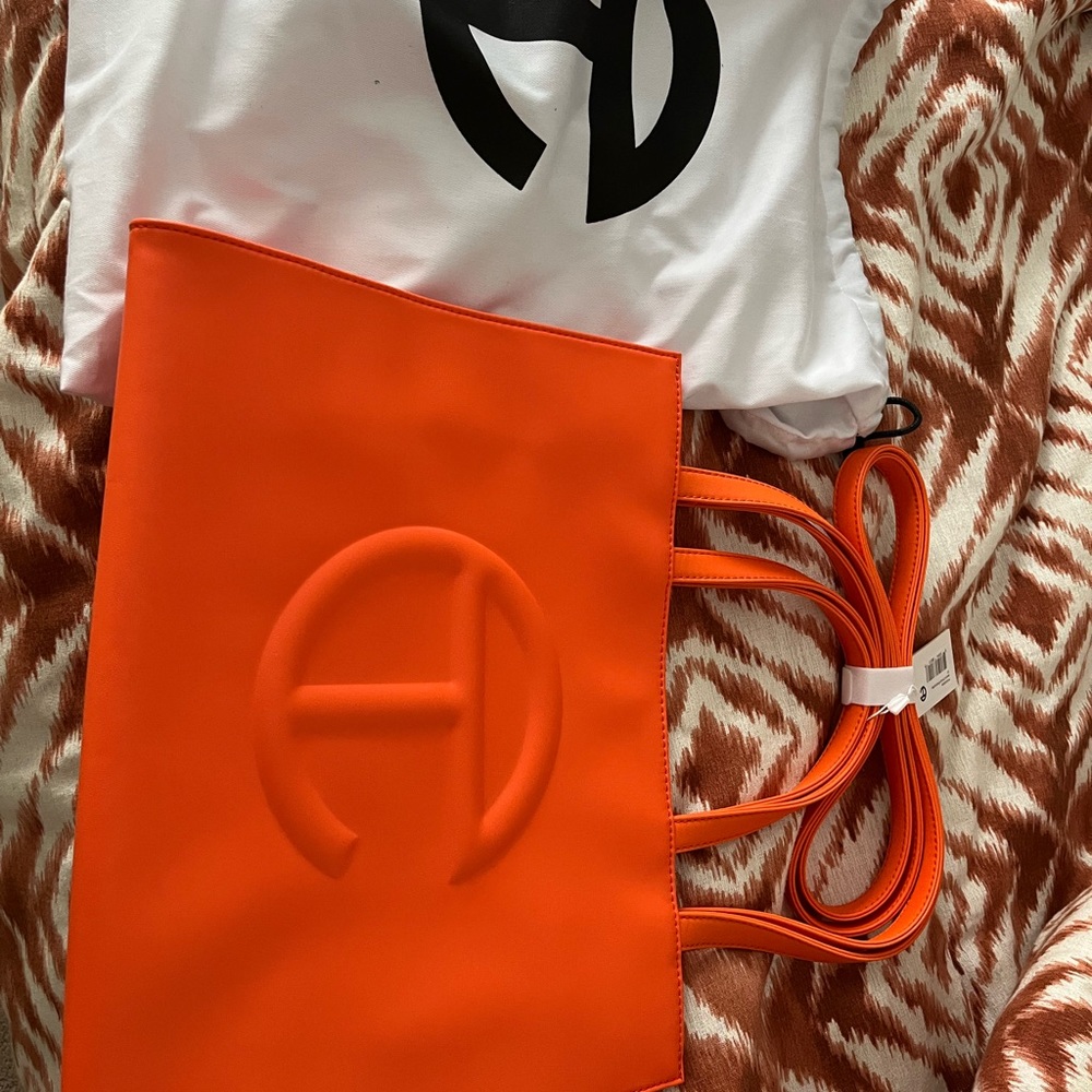 Never worn, new with tags, orange medium Telfar.